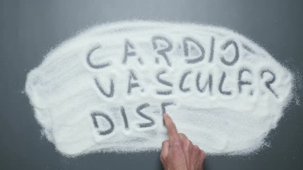 Text Cardiovascular disease written on sugar background. Sugar kills. alt