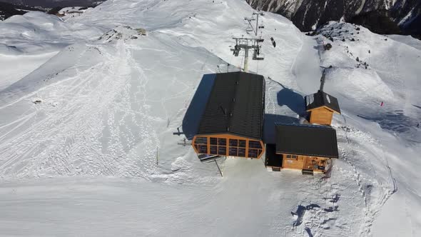 Majestic Winter Aerial Landscape and Ski Resort with Typical Alpine Wooden Houses in French Alps