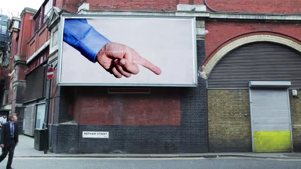 Billboard pointing at pedestrian