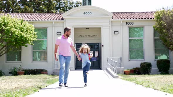 Happy Father and Son Holding Hands Running and Having Fun After School Slow Motion Parenthood