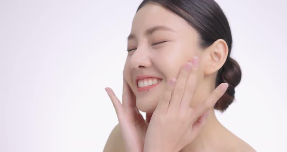 Close Up Of Young Beautiful Asian Woman Touch Her Face Gently With Fingertips. alt