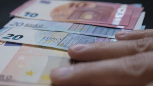 Male hand  spreading  Euro   currency debts or deposits on  table slow-mo 1080p HD video - Slow moti alt