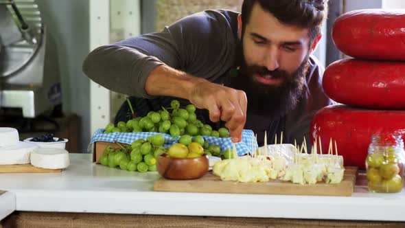 Male staff arranging food items at the counter alt