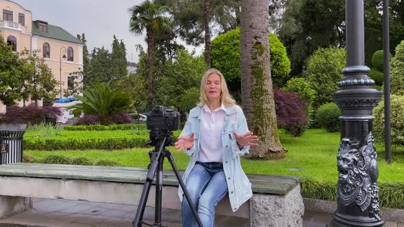 Blogger Filming Herself on Camera in the Garden