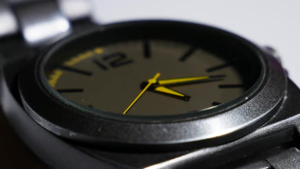 The Movement Of The Yellow Hands Of A Wristwatch. The Movement Of The Hands Of A Quartz Wrist Watch. alt
