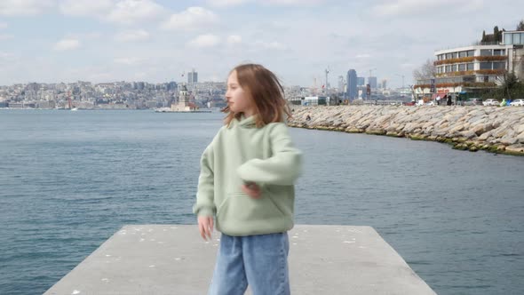 Beautiful Teenage Girl Dancing on Seashore in Istanbul alt
