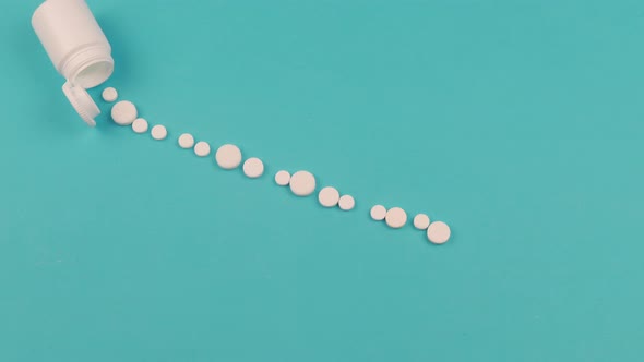 4K Stop motion animation of white pill on blue background