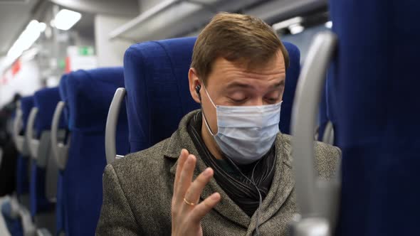 Excited Male Wearing Medical Face Mask Looks at Phone and Celebrates Big Win Financial News alt