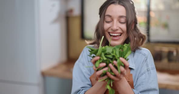 Housewife Enjoying Fresh Spinac While Cooking alt