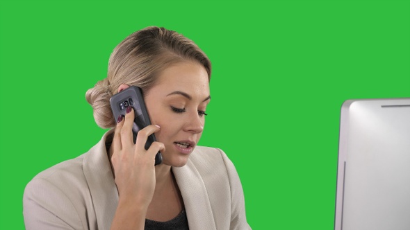 Young Office Woman Talking to Someone on her Mobile Phone alt