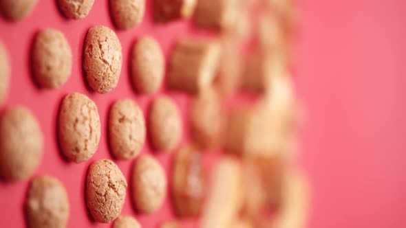 Vertical video, Close-up: puff pastry biscuits rotate on a stand in a glass cloche alt