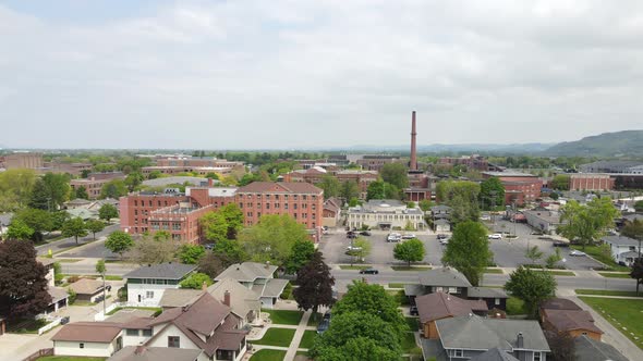 Neighborhood with residences, businesses along with university buildings with maintained yards.