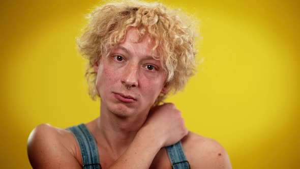 Front View of Queer Man Looking at Camera Stretching Hand in Slow Motion alt