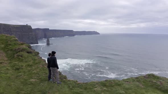 Aerial View of Beautiful Irish Cliffs of Mother Young Couple Watch the Landscape Panorama
