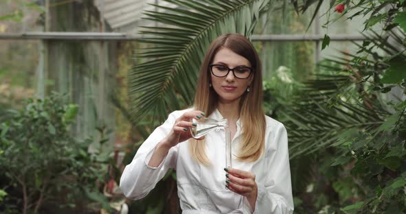 Female Woman Ecologist Scientist Biologist Researcher with Test Tube Liquid alt