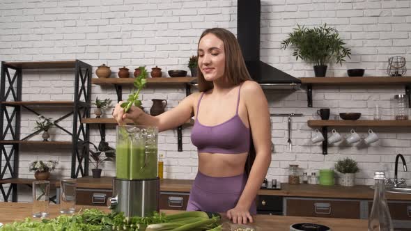 Making Green Juice at Home Attractive Fitness Woman in Sportswear Blending Healthy Green Smoothie  alt