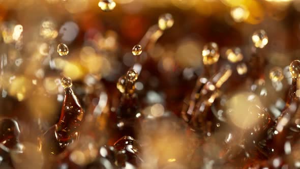 Super Slow Motion Shot of Splashing Brown Alcohol Liquid at 1000Fps alt