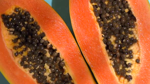 Tropical Fruit Papaya on a Colored Sunny Background with Shadows of a Palm Tree alt