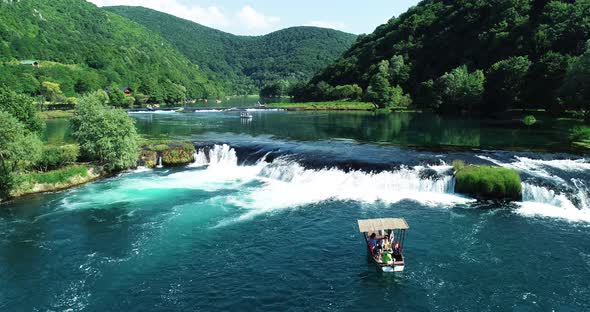 Aerial view of a boat sailing the Una River, Croatia. alt
