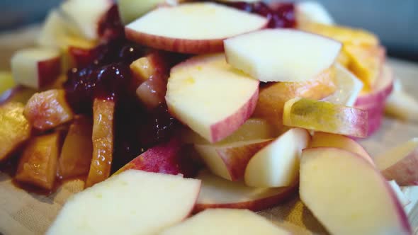 Rotating view of a pile of fresh fruit on a wooden board alt