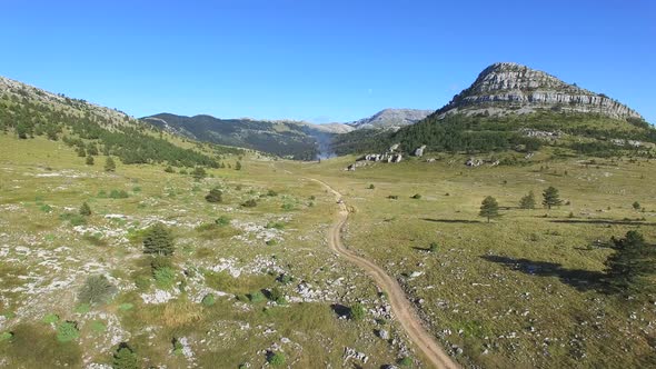 Smoke rising above Dinara hills alt