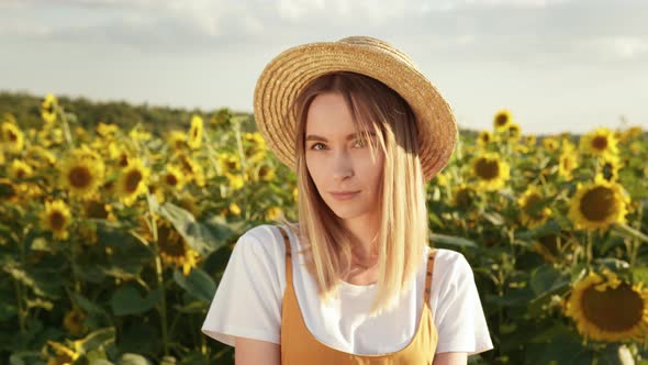 The Woman is Looking at the Camera and Smiling alt