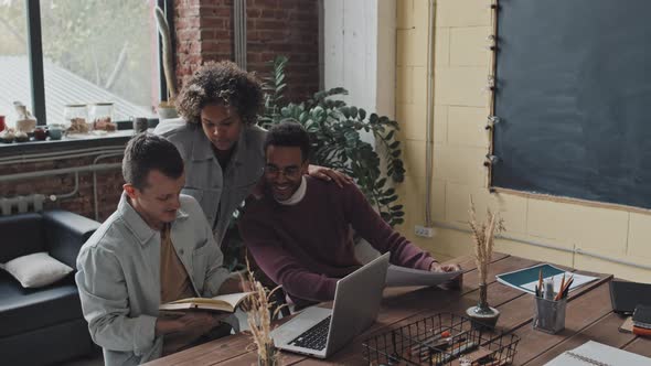 Young Woman Helping Men at Work alt