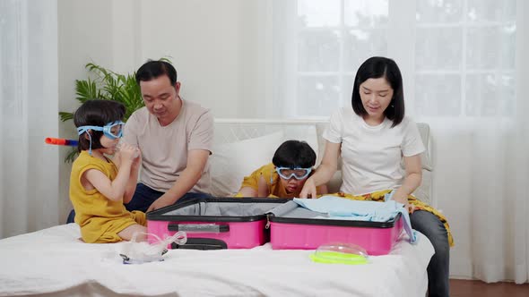 Asian family preparing clothes for luggage for tourism, concept of relaxation, travel, adventure