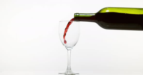 900125 Red Wine being poured into Glass, against White Background, Slow motion 4K alt