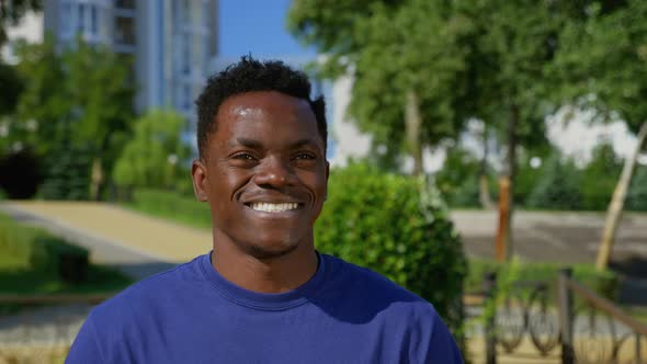 Portrait Smiling Afroamerican Man Ethnic Black on Background Trees in Summer alt