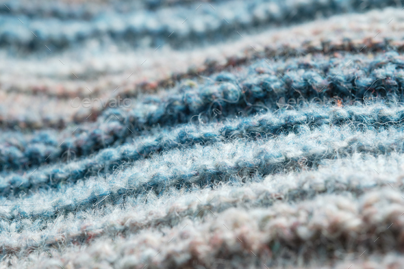 Knitted background. Knitted fabric texture, pure sheep wool, color gradient.