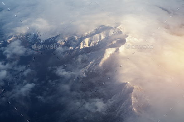 Mountain range and white clouds in blue sky at day - Stock Photo - Images
