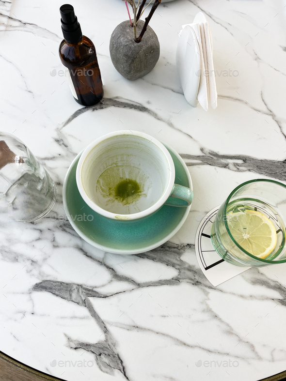 Table at cafe with an empty cup from matcha - Stock Photo - Images