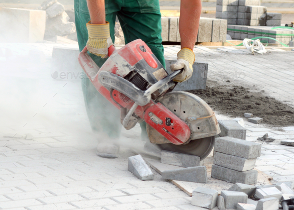 Industrial worker working with concrete saw