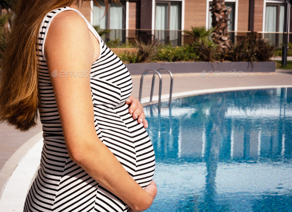 Woman Belly on the Swimming Pool Stock Image - Image of closeup