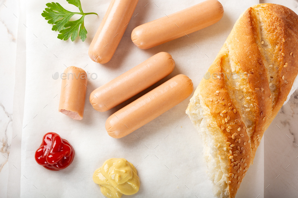 Small sausages with bread, ketchup and mustard - Stock Photo - Images