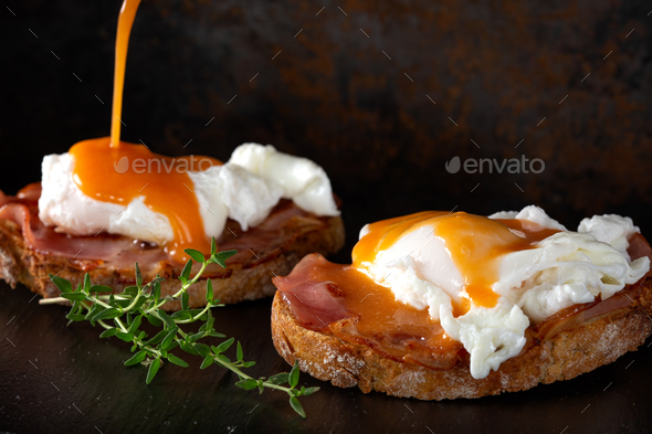 Pouring sauce over benedict eggs - Stock Photo - Images