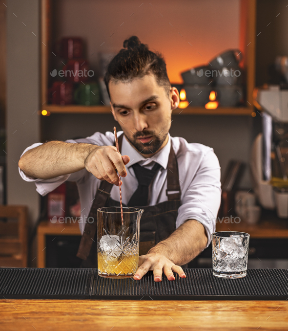 Barman stirring fresh alcoholic cocktail - Stock Photo - Images