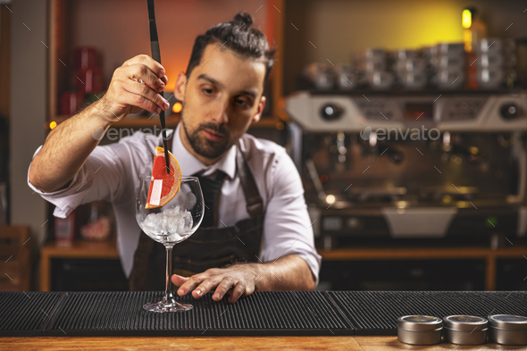 Barman decorating goblet glass - Stock Photo - Images