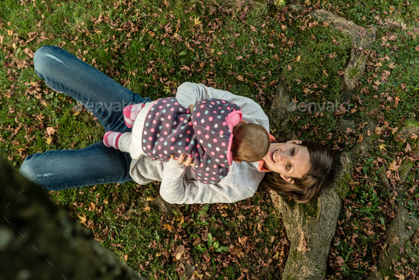 Aerial view of happy mother playing with her baby girl - Stock Photo - Images