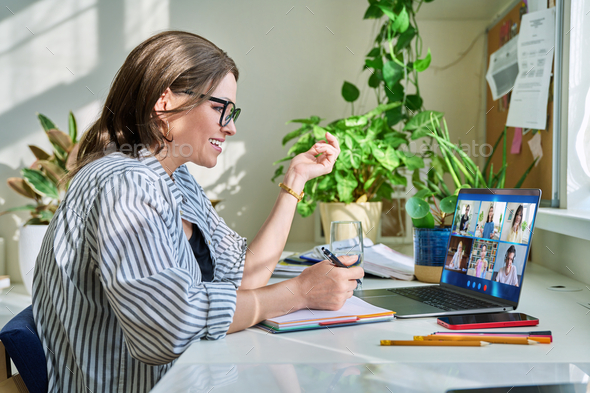 Female teacher working at home, online lesson with group of teenage students - Stock Photo - Images