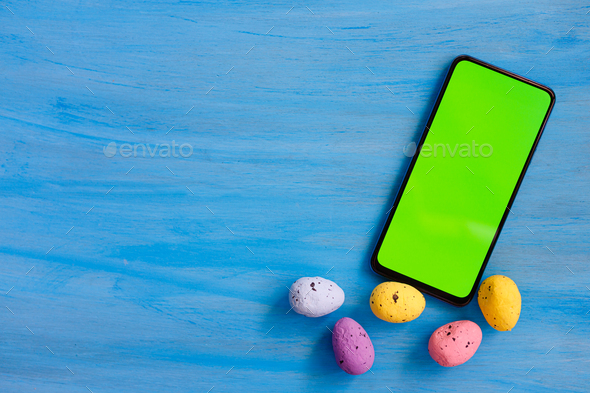 Phone smartphone, green screen on Blue wood background top view - Stock Photo - Images