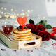 Valentine&#39;s day composition with breakfast, gift box and roses. Stack of delicious pancakes - PhotoDune Item for Sale