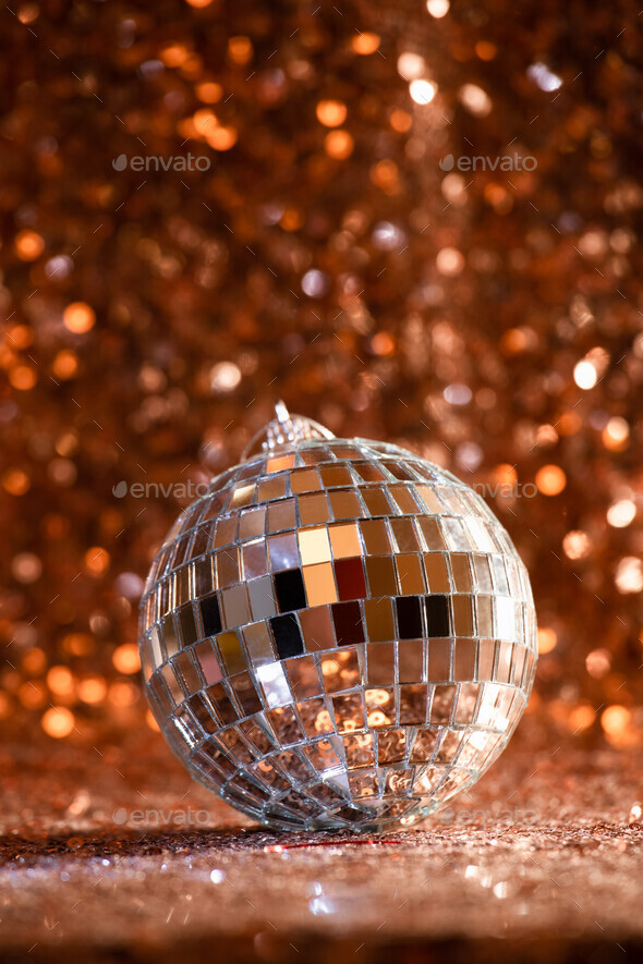 disco ball on rose gold sequin background
