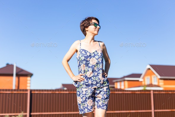 Cheerful woman in home wear pajama outdoor on backyard background emotions - sleepwear and homewear - Stock Photo - Images