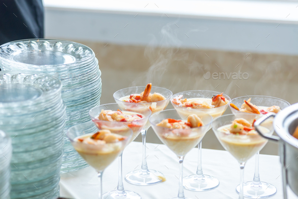Shrimp & grits side dish appetizer in fancy martini cocktail glasses -  steaming hot southern comfort Stock Photo by wirestock