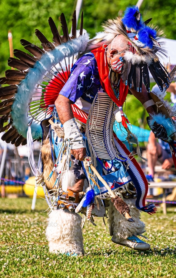 Vertical closeup shot of a person in a colorful traditional native Indian-American festive costume