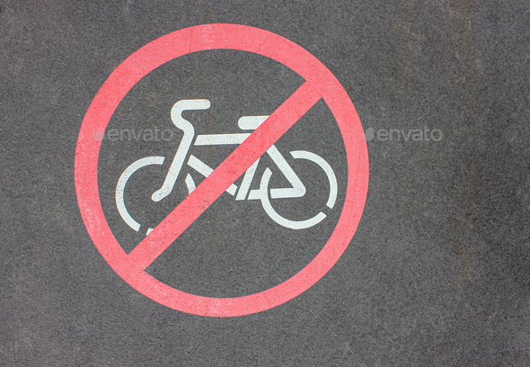 No Biking Allowed. Circular red traffic sign. White bicycle Symbol Painted over gray Asphalt.