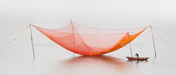 Panoramic shot of a fishing net suspended on the surface of the Thu Bon  River in Vietnam, Asia Stock Photo by wirestock