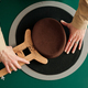 Above angle of pork pie hat and hands of craftswoman with wooden tool - PhotoDune Item for Sale
